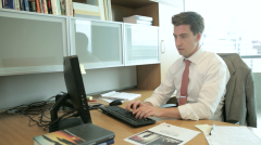 Casey Mahoney in front of computer at office