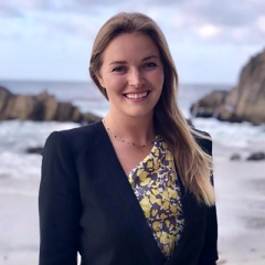 Andrea Fisher standing in front of the ocean