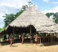 Indigenous people of the Bora community gathers together in a straw hut in Iquitos, Peru