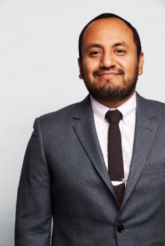 Mr. Alvaro Sanchez wearing a suit and tie and smiling