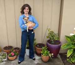 Lauren DaSilva holding a dog outside