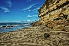 coastal cliff with blue sky and blue water--in Tasmania