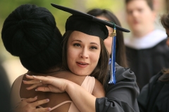 Two graduates embrace at Commencement 2023