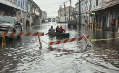 Paddlers navigate the flooded Custom House Wharf in Portland, ME 