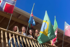 McKenzie Ploen, Emma Holm-Olsen, Amany Darkaoui, and Sylvie Alexander with the Brazilian flag on Middlebury Institute of International Studies campus before they head to COP30 in Belém, Brazil. 