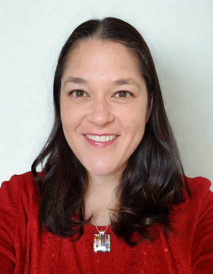 Brunette woman with medium length hair wearing red sweater
