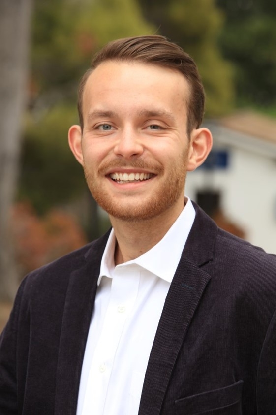 Walden Kiker looking happy, smiling, clean cut, reddish hair and slight mustache and beard