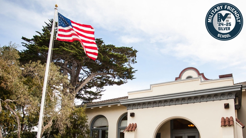 An American flag flies outside the Segal Building, at the center of campus.