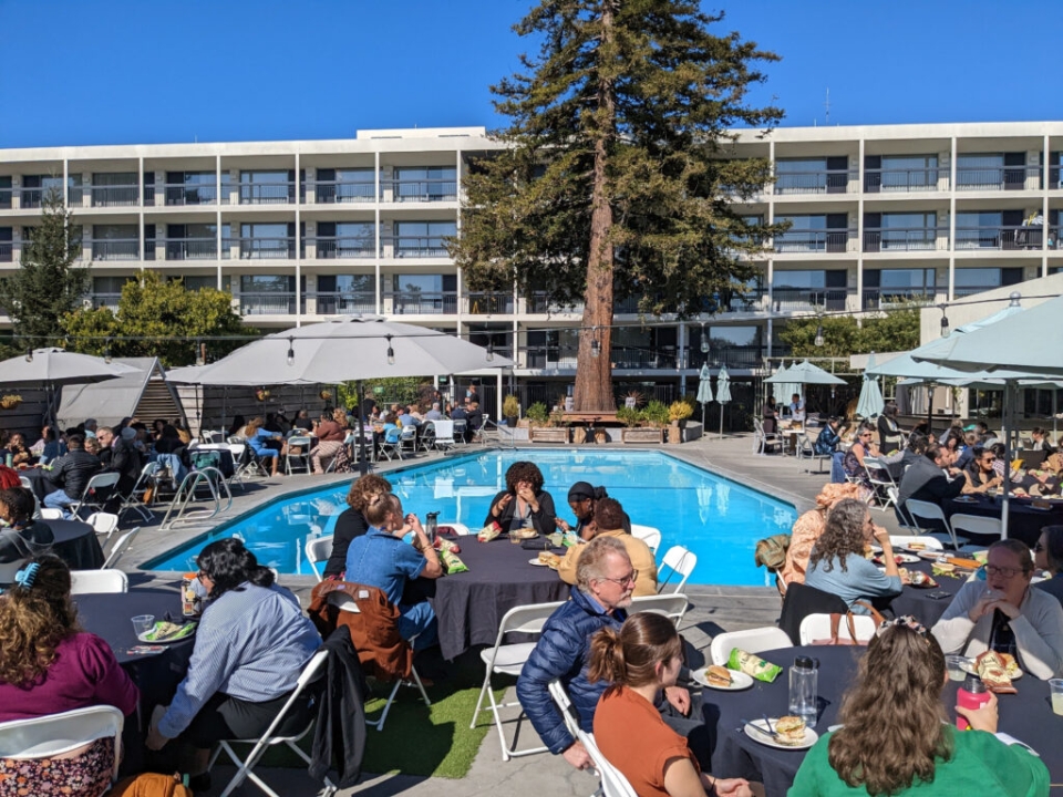 People sitting around a pool talking