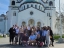 a group of students posing in front of a church in the Balkans