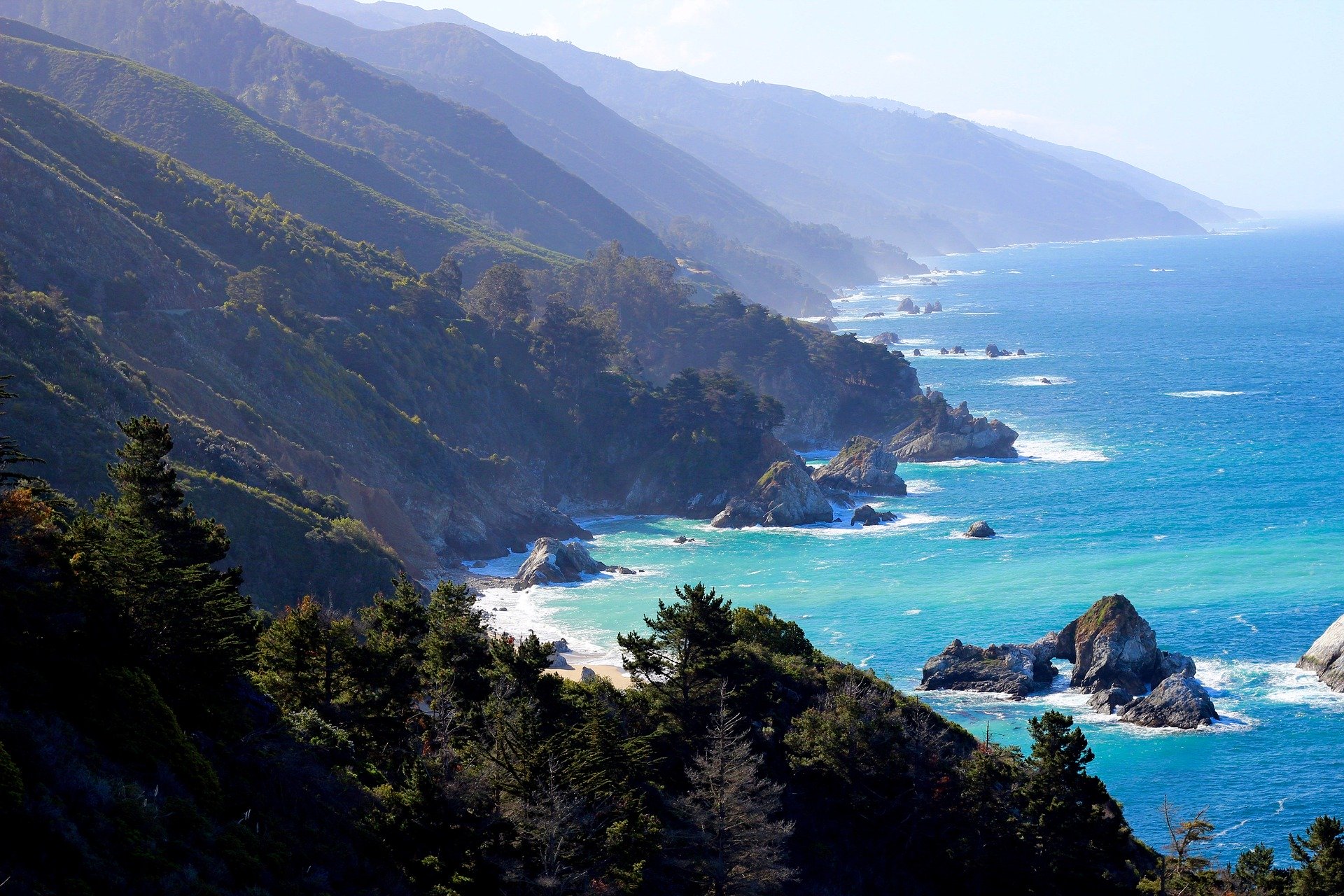 dramatic coastline of Big Sur, California.  Coastal mountains meeting turquoise blue ocean.