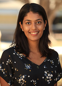 Prati Rosen, professional headshot, confident smile, bright and intelligent eyes, long dark hair