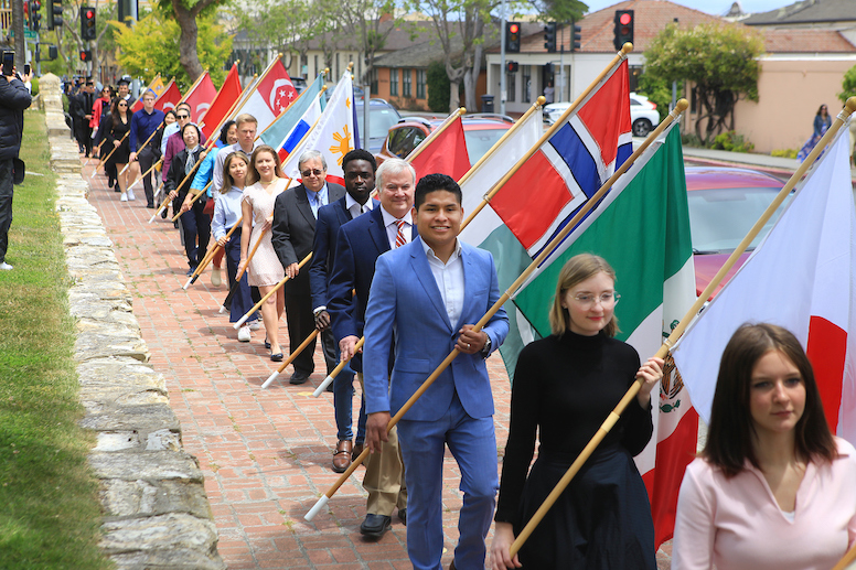Students carry flags in procession to kick off Commencement 2023
