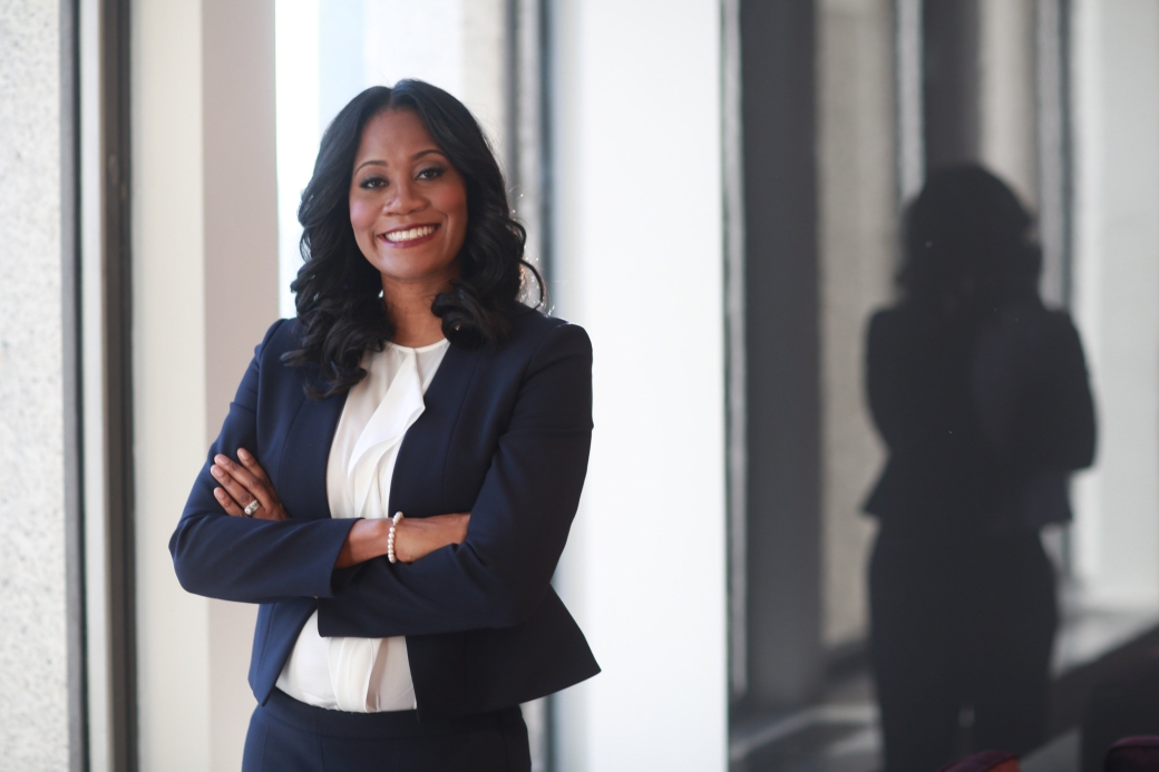 Profile image of Nykeesha Damali Peterman, smiling with arms folded