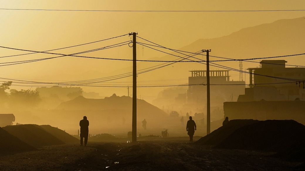 Silhouette of two people walking at dawn in Kabul, Afghanistan