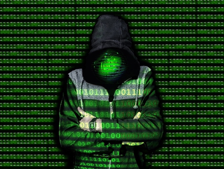 man in hoodie overlayed with code