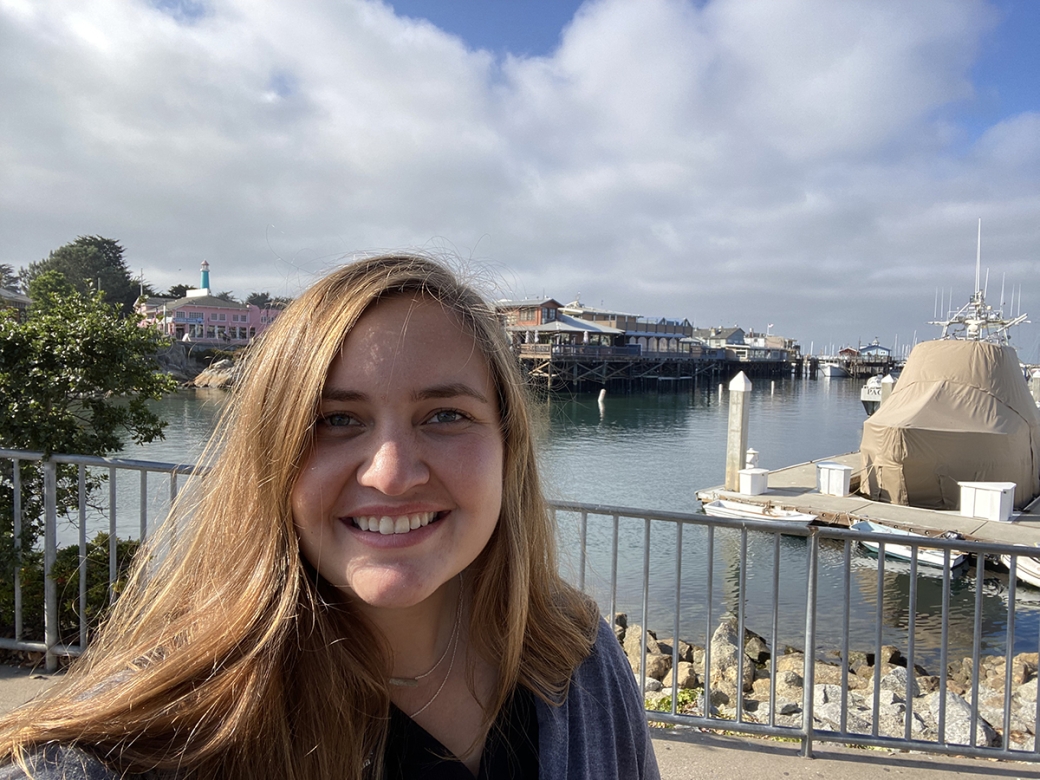 Photo of Middlebury Institute student Katarina Zomer in front of the wharf in downtown Monterey, CA.
