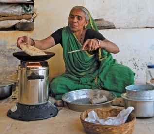 Woman using a clean cook stove Woman using a clean cook stove