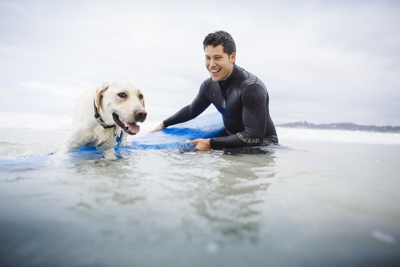Justin Arrington surfing with his dog