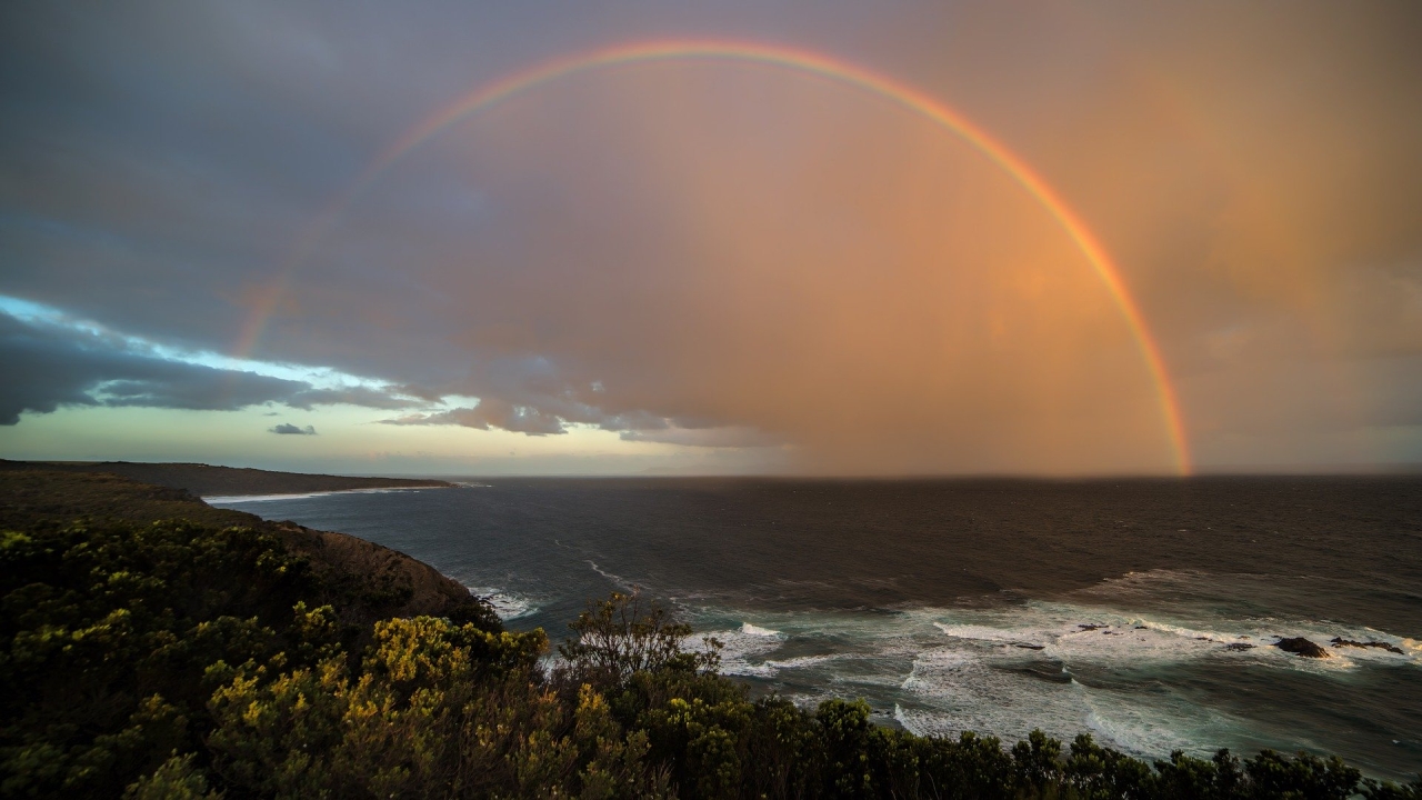 Rainbow over cliffs and ocean