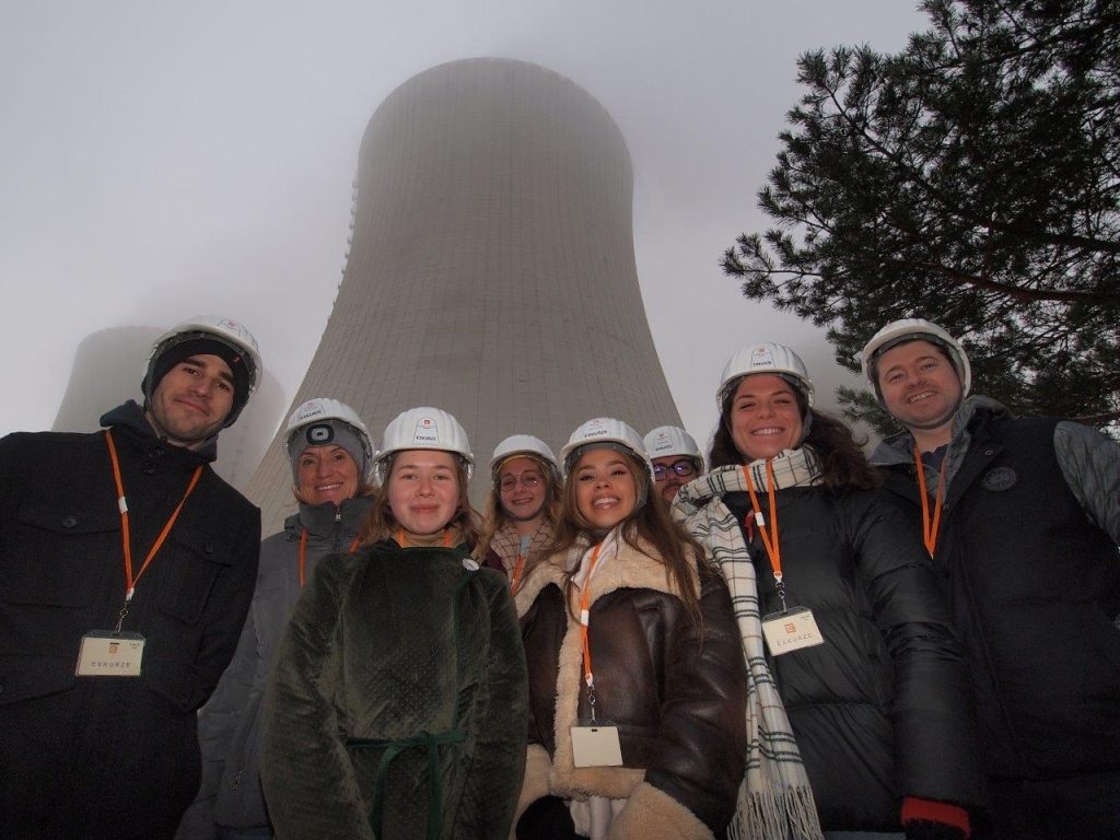 a group of students posing in front of a nuclear reactor in the Czech Republic