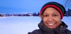 Kimberly Aiken headshot in front of a field of snow at twilight