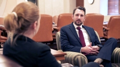 Loren Hall, international trade and economic diplomacy alumnus, sitting in a D.C. office with a female colleague