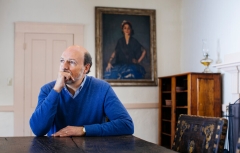 Man sitting by table pensively