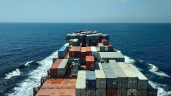 Cargo ship in the ocean with lots of containers onboard