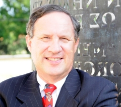 Dr. Christopher F. D'Elia, Professor and Dean, College of the Coast and Environment, Louisiana State University smiling and wearing a blue pinstripe suit