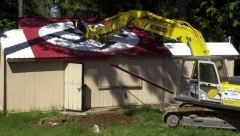 Image of Aryan Nations compound being demolished.
