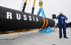 A big black pipe with white letters "RUSSIA"  marks the Nord Stream project