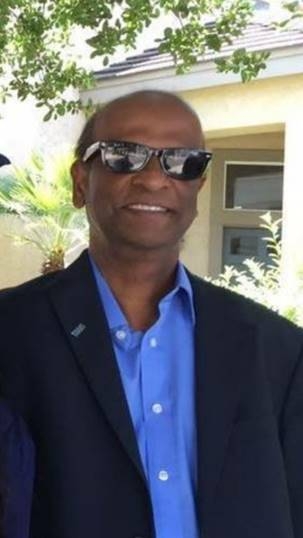 Head shot of Jerome Sigamani wearing sunglasses