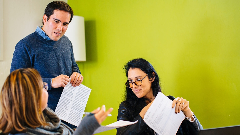 Students work with a faculty member in the Graduate Writing Center, one of several academic resources available.