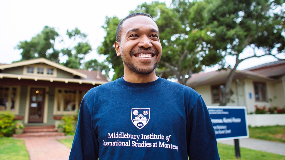 Profile photo of a smiling student outside of the Student Services building.