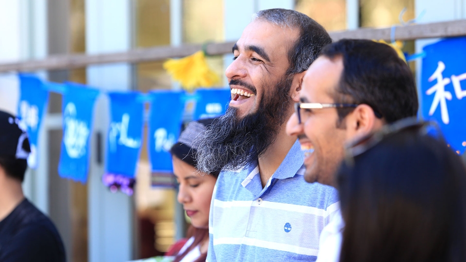 Two laughing students are enjoying a club-organized event.