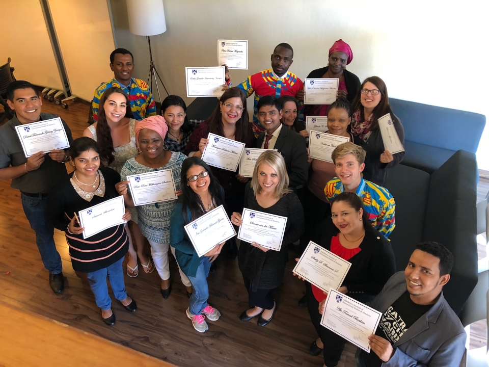 Group of teachers holding up completion certificates