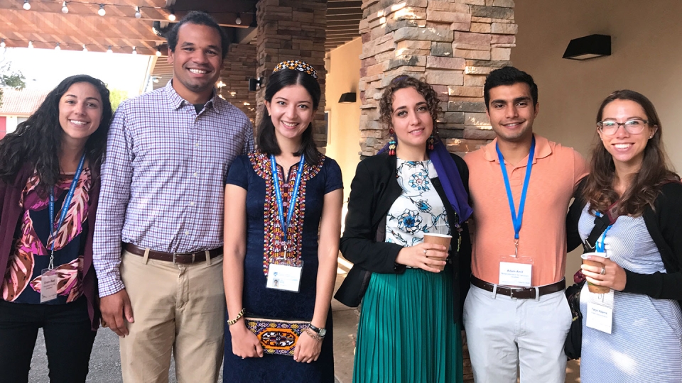 A friendly group of international students are ready to greet new students at the Welcome Center.