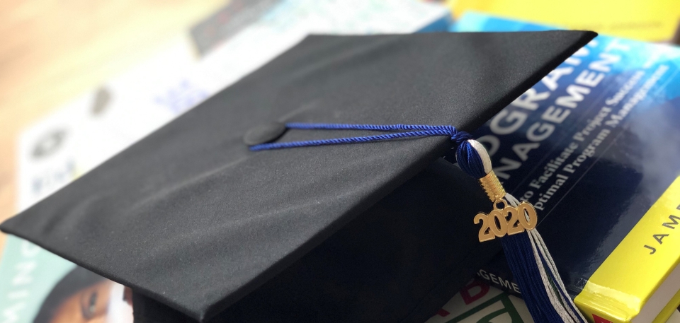 Cap with tassel on books