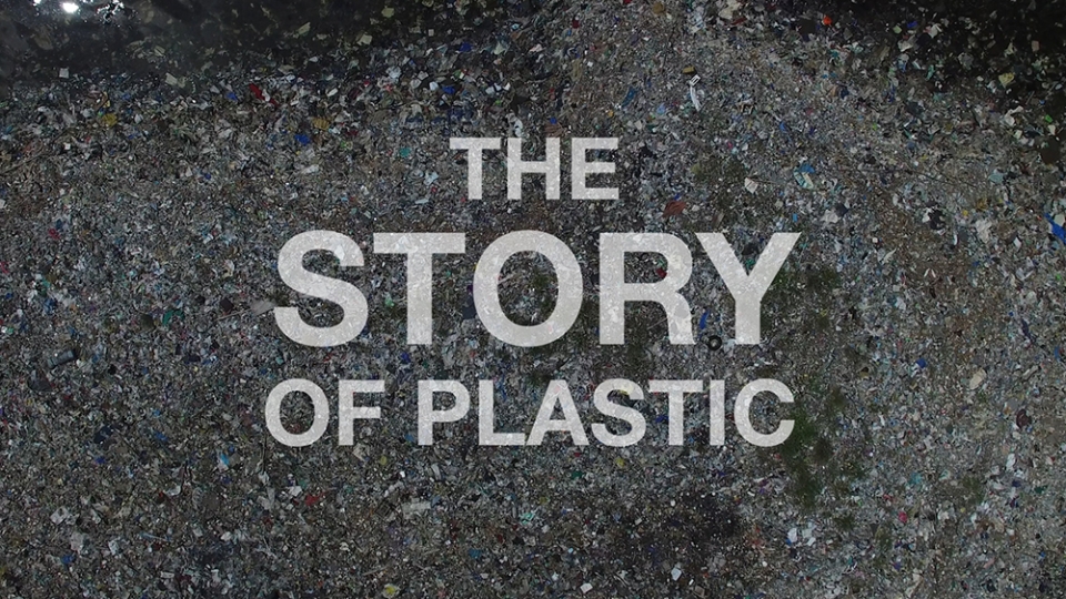 Title card for The Story of Plastics, white words over a grey mountain of plastic bits