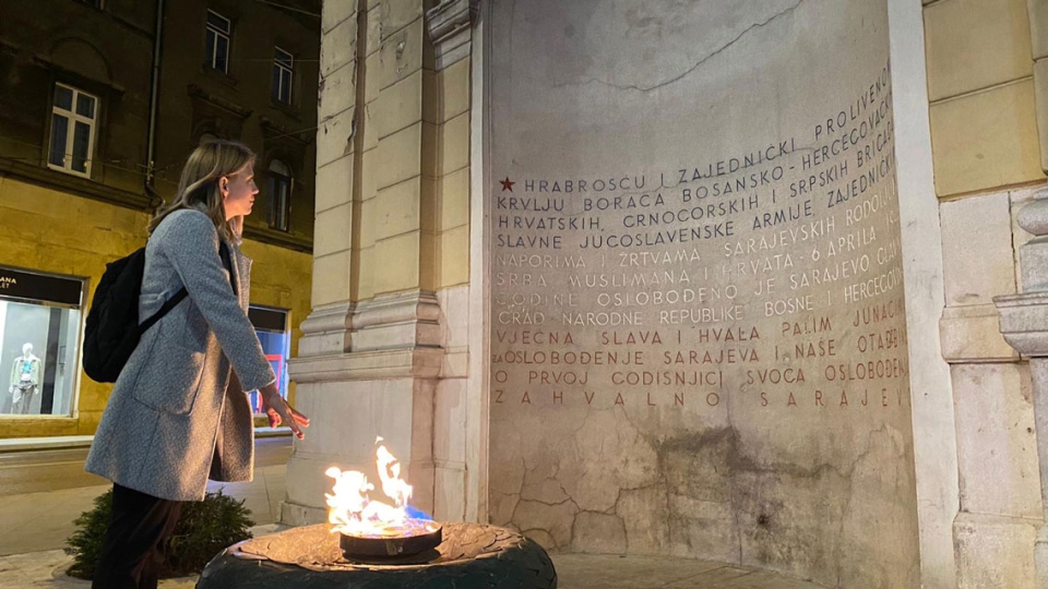 Kathleen Rabe (MA IPD '23) standing in front of Vječna Vatra (The Eternal flame) in Sarajevo, Bosnia and Herzegovina. 