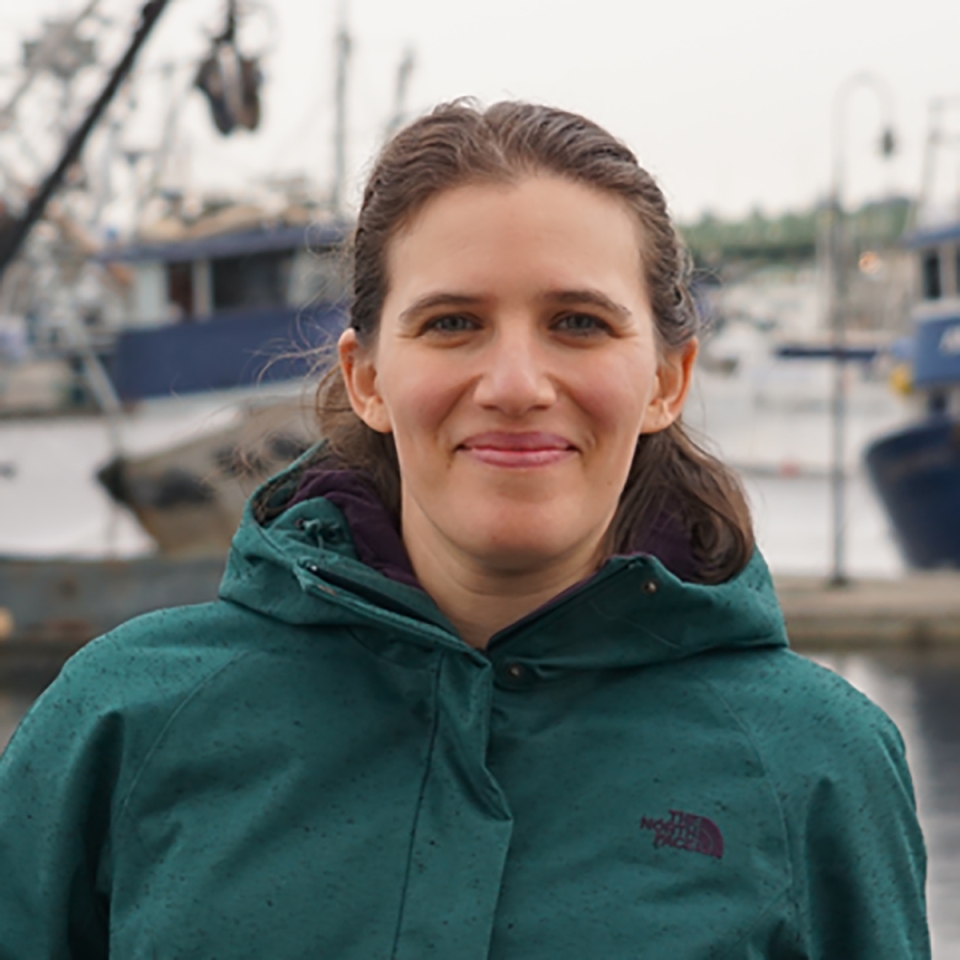 Rachel Aronson looking directly at the camera, serious and engaged, she is slightly smiling.