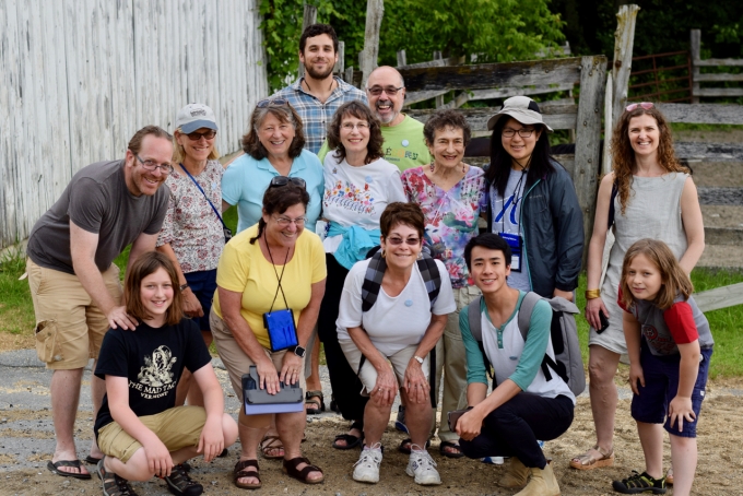 Group of Hebrew Lifelong Learners sitting outside on steps of building.
