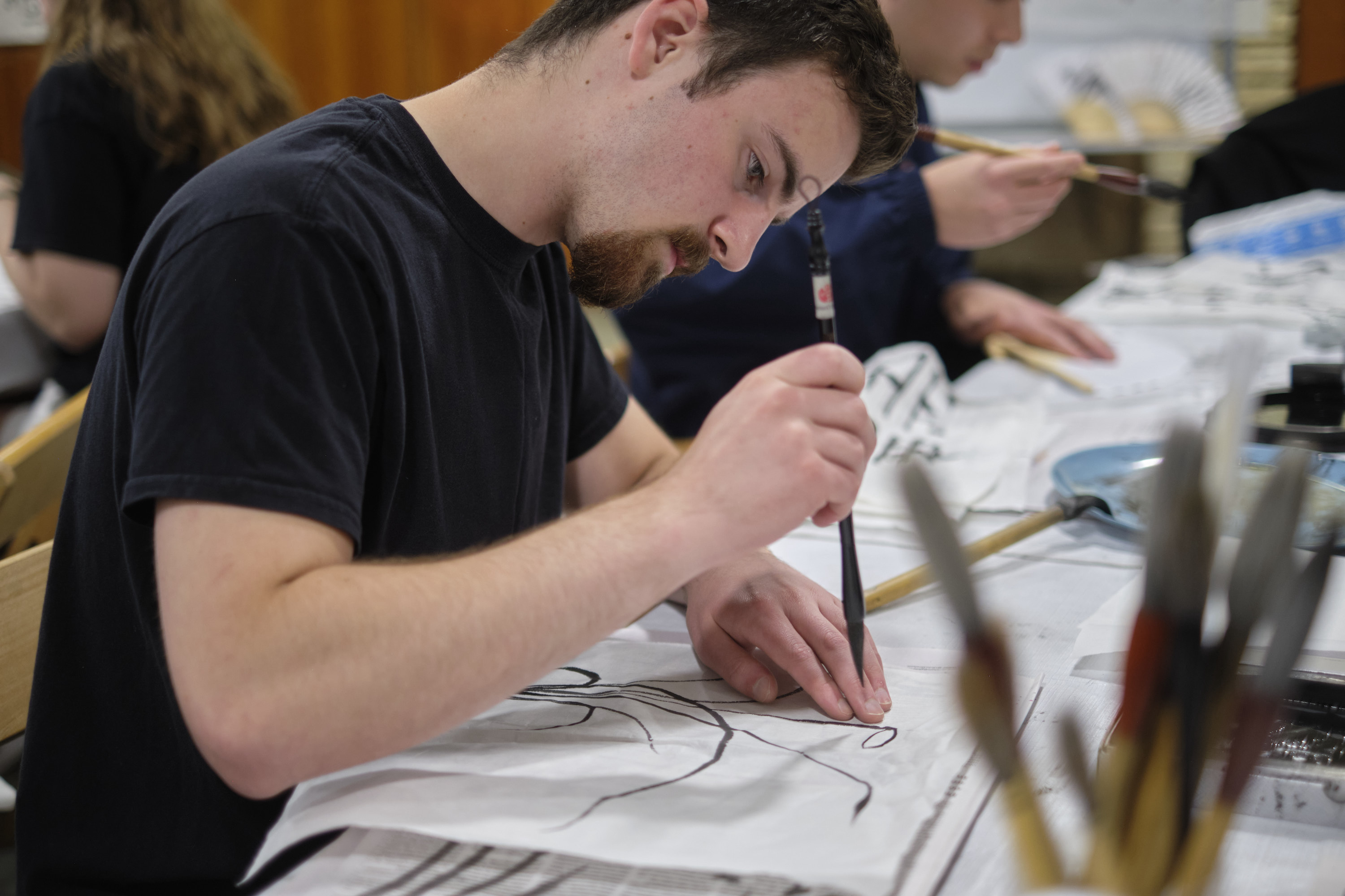 A student does Korean calligraphy using a brush.