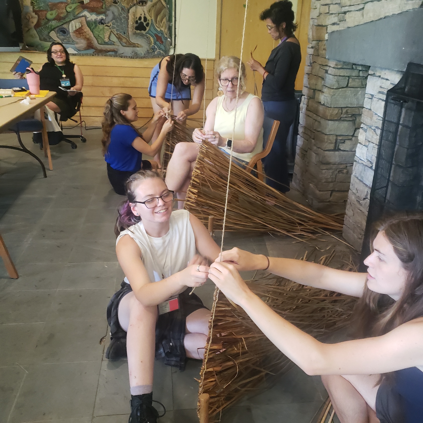 Students work with wood, building together. 