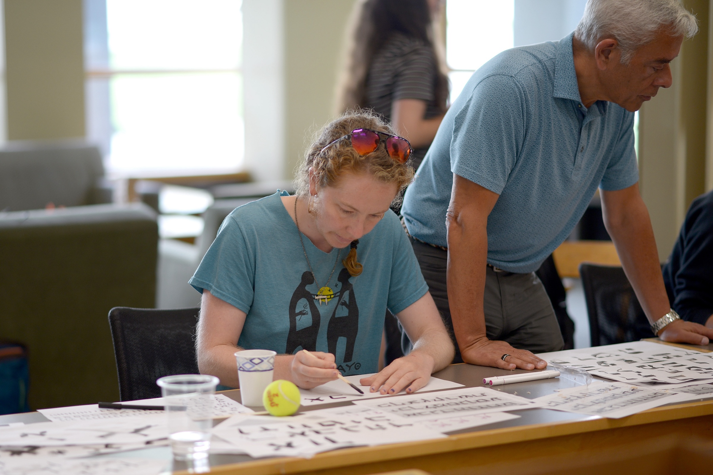 A woman does calligraphy. 
