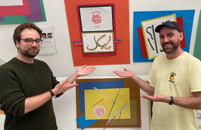 Arabic students showing colorful pictures.