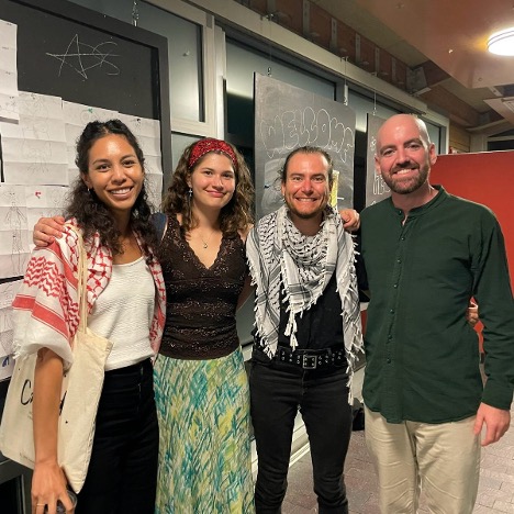 four Arabic School students smiling at the camera. 