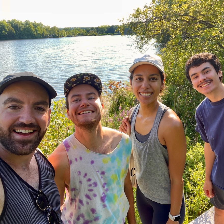 Arabic School students smile in front of a lake. 