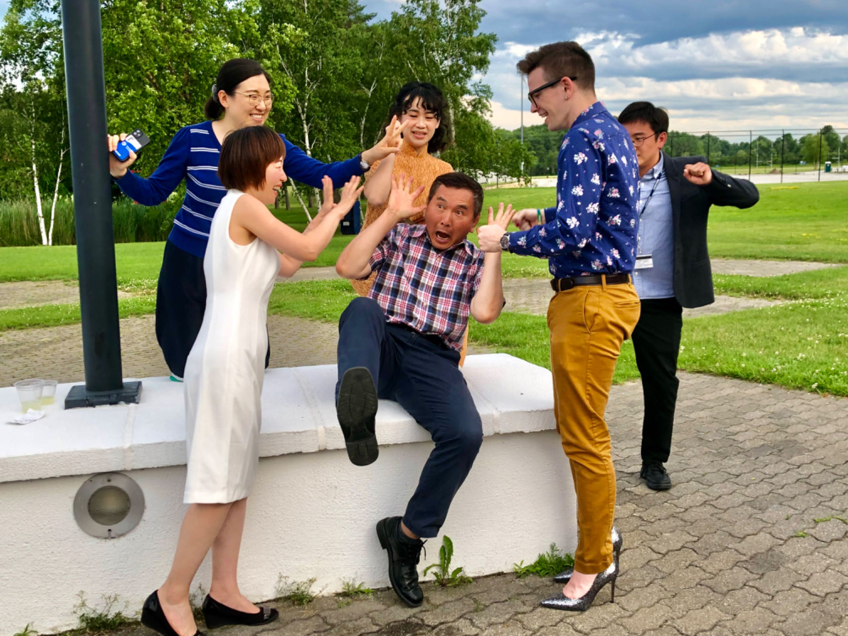 Teachers pretend to help a man as he "falls"